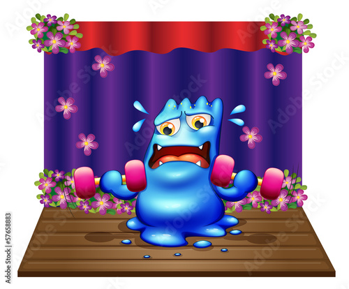 A blue monster exercising in the middle of the stage