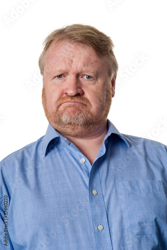 Puzzled middle aged bearded guy in blue shirt - on white
