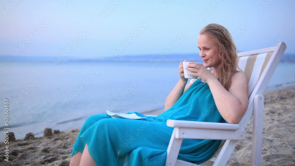 Woman enjoying a cup of tea at the seaside Woman enjoying a cup of tea at the seaside