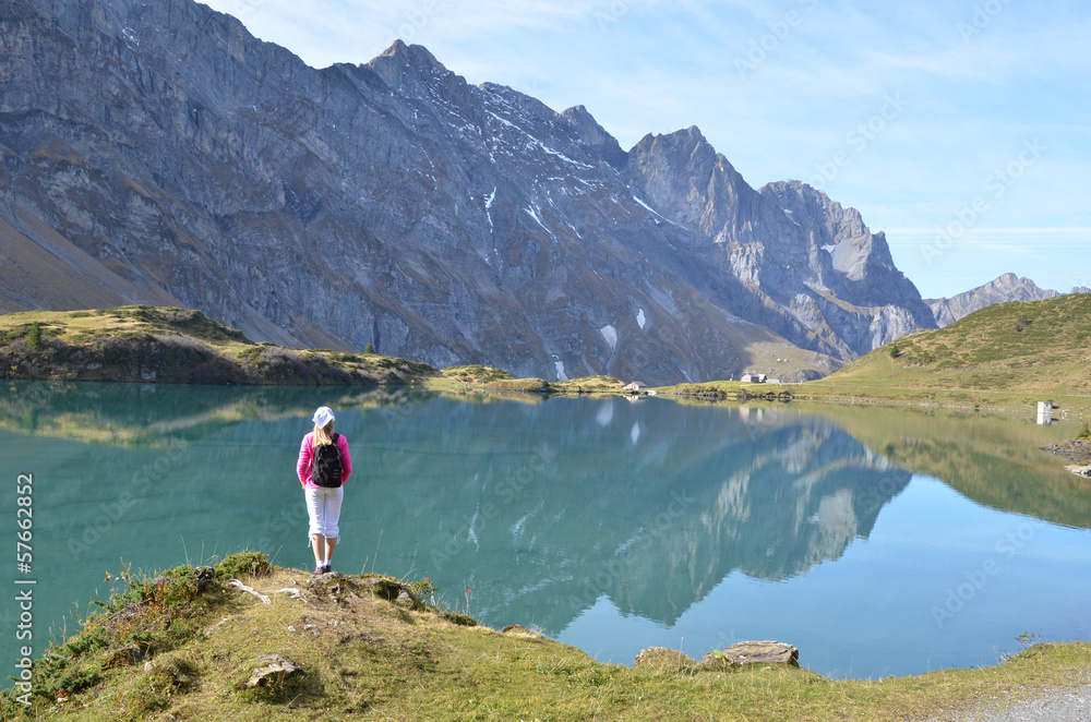 Girl enjoying Alpine panorama. Switzerland - obrazy, fototapety, plakaty 