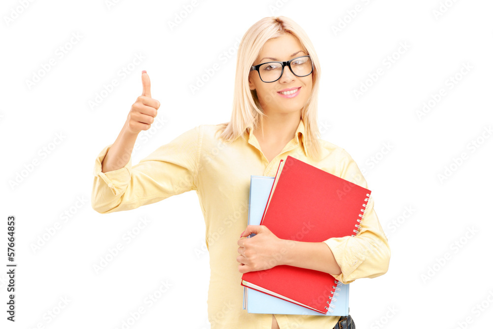 Female student giving a thumb up and holding notebooks Female student giving a thumb up and holding notebooks