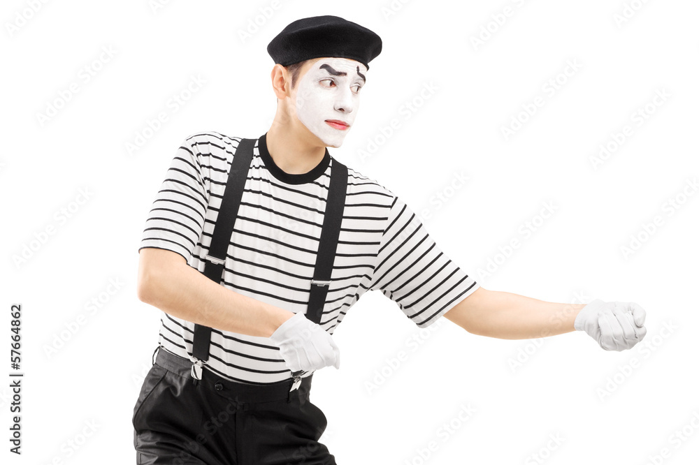 Male mime artist performing pulling virtual rope Male mime artist performing pulling virtual rope