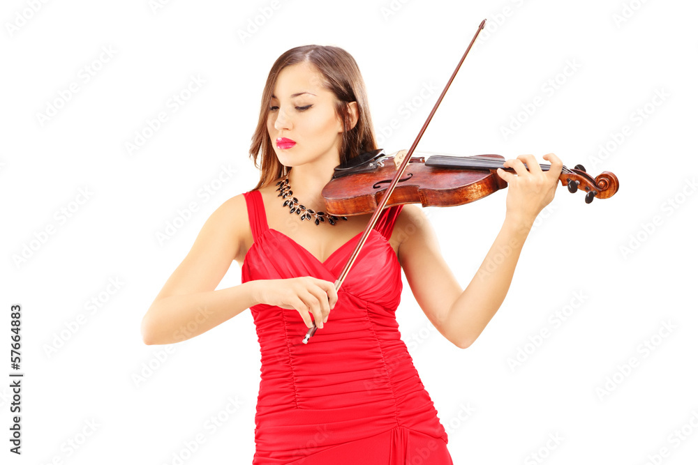 Young attractive female in red dress playing the violin Young attractive female in red dress playing the violin