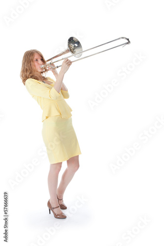 young woman in yellow mini dress playing the trombone