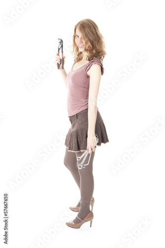 young pretty woman with ring spanners and pipe wrench