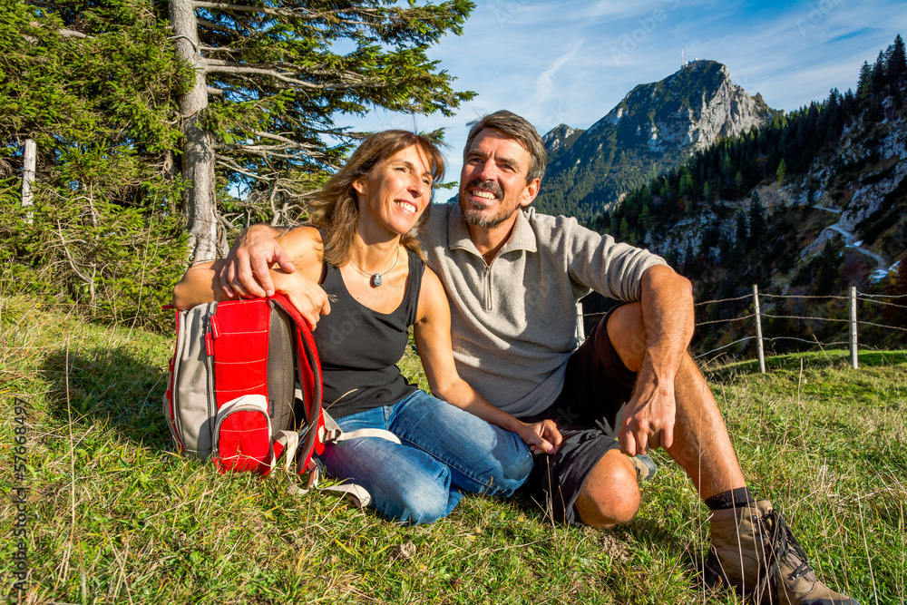 Fototapeta premium Paar macht Pause auf einer Wiese in den Bergen