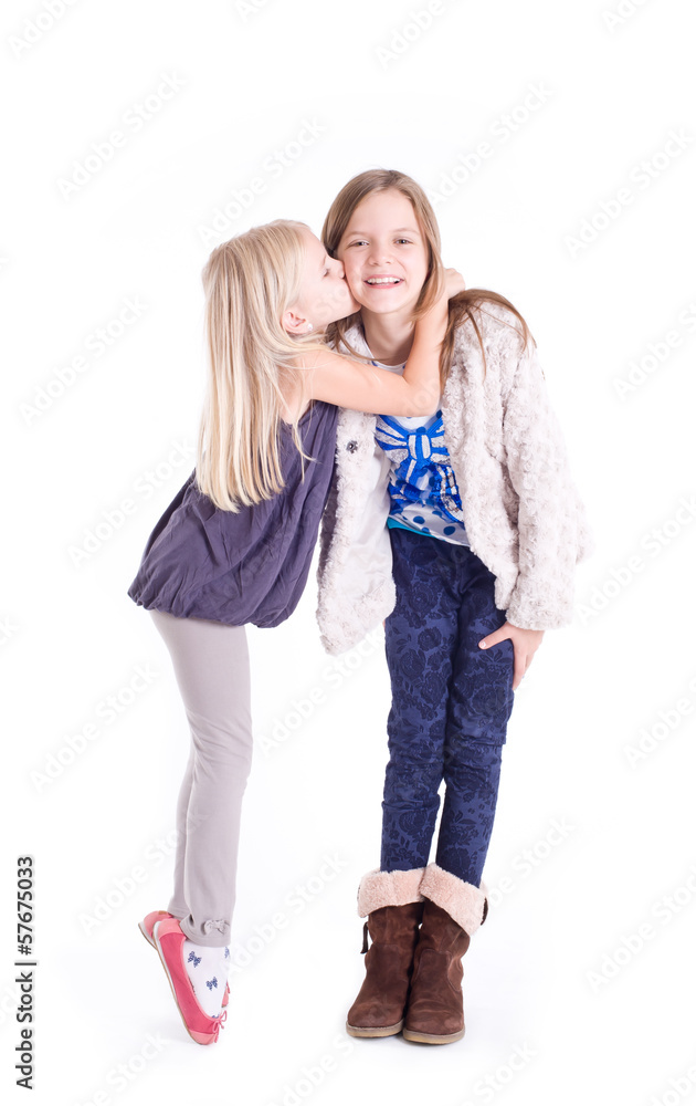 Little girl kissing her older sister. Little girl kissing her older sister.