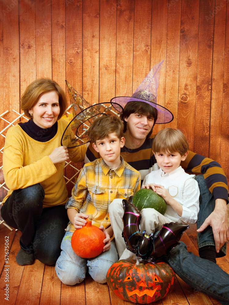 The family sit with Halloween's carved pumpkin