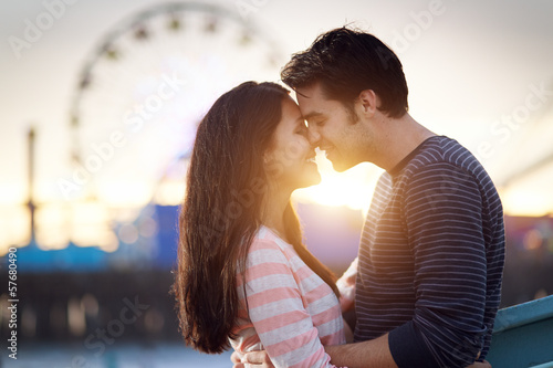 romantic couple in front of santa monica amusement park photo