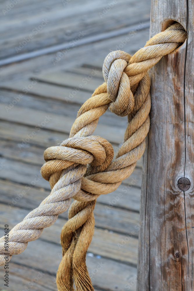 Rope and knot attached to wooden pole