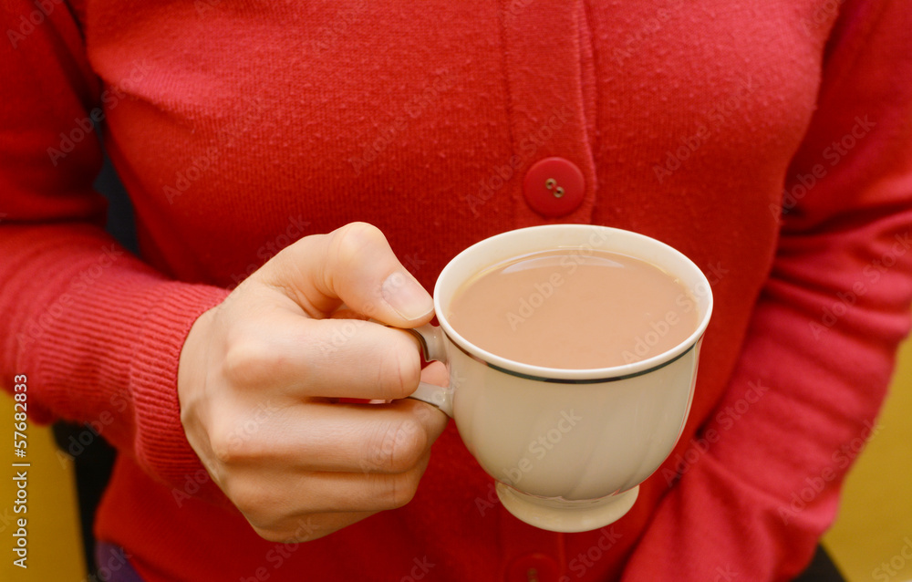 Cup of tea in a woman's hand Cup of tea in a woman's hand