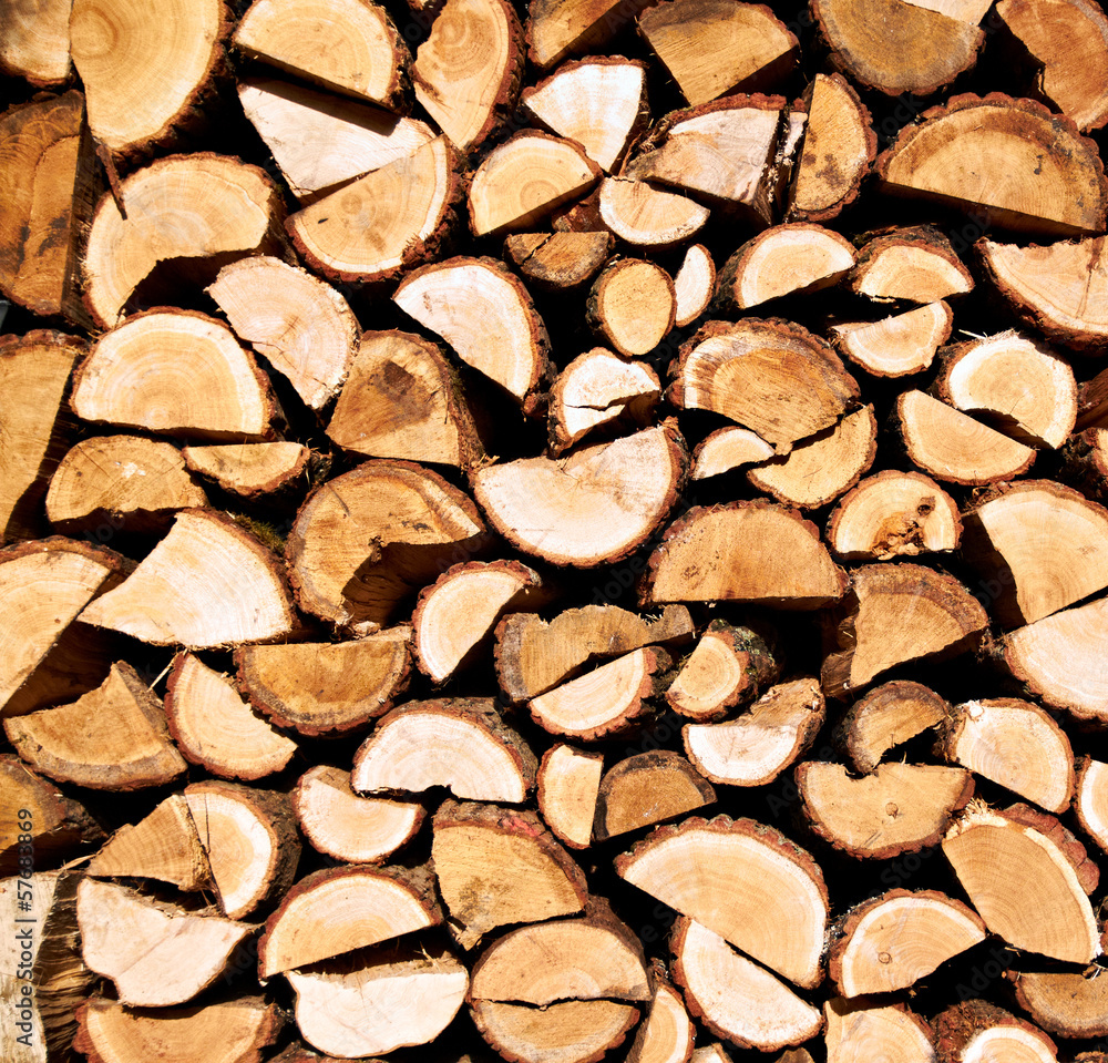 Background of dry chopped firewood logs stacked up on top of Background of dry chopped firewood logs stacked up on top of
