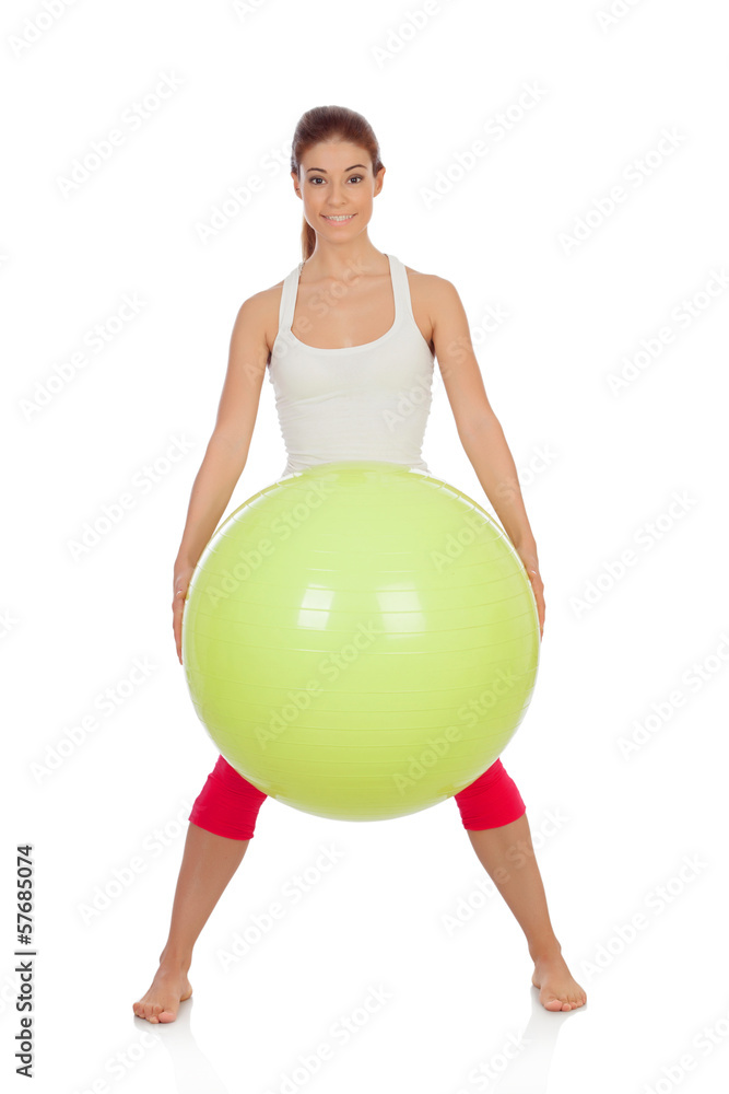 Attractive woman doing pilates with a big green ball Attractive woman doing pilates with a big green ball