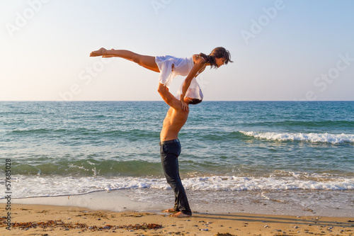 Young couple practicing a dance scene at the beach.