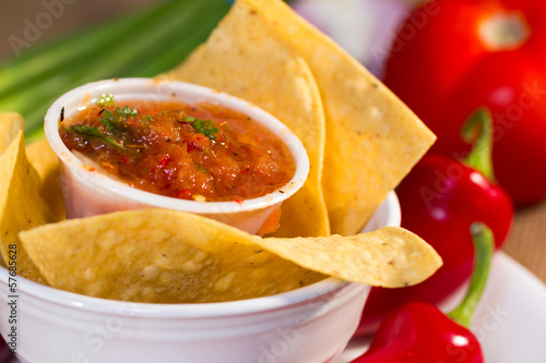 Red roasted tomato salsa with corn chips.