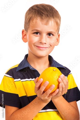 Boy holding oranges photo