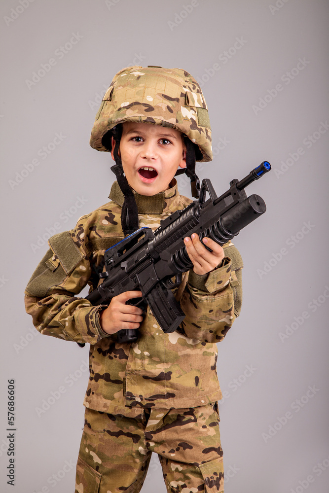 Young boy dressed like a soldier with rifle Young boy dressed like a soldier with rifle