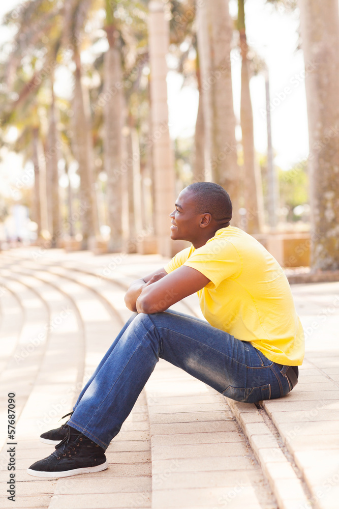 black man outdoors sitting on steps black man outdoors sitting on steps