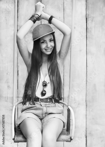 hipster girl sitting on a swing