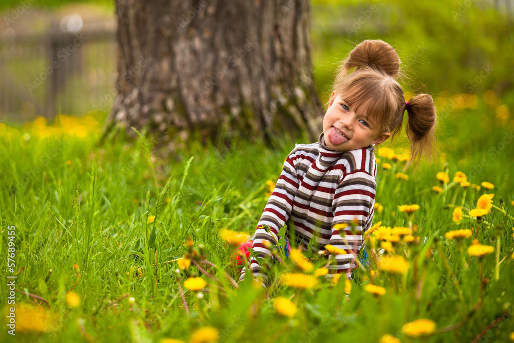 Funny lovely little five-year girl in park Funny lovely little five-year girl in park