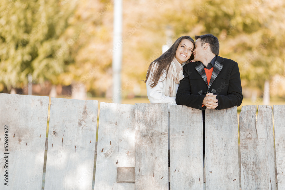 Fototapeta premium Young couple by the fence
