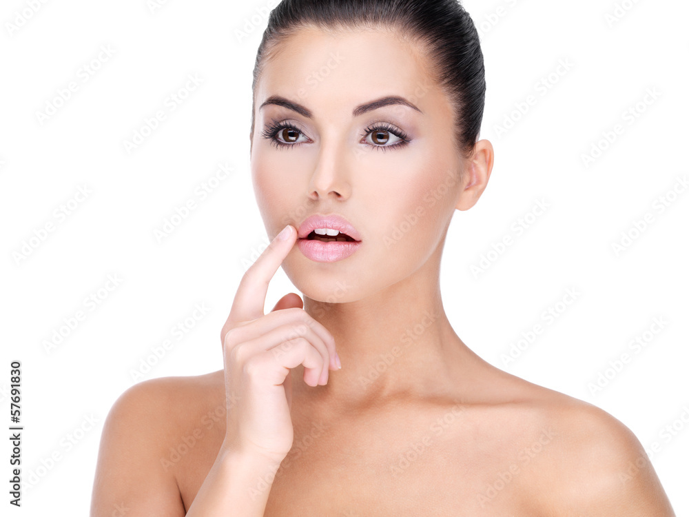 Face of a Pretty young woman with finger at  lips