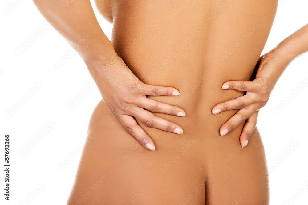 Woman holding her lower back, feeling spine ache. Woman holding her lower back, feeling spine ache.