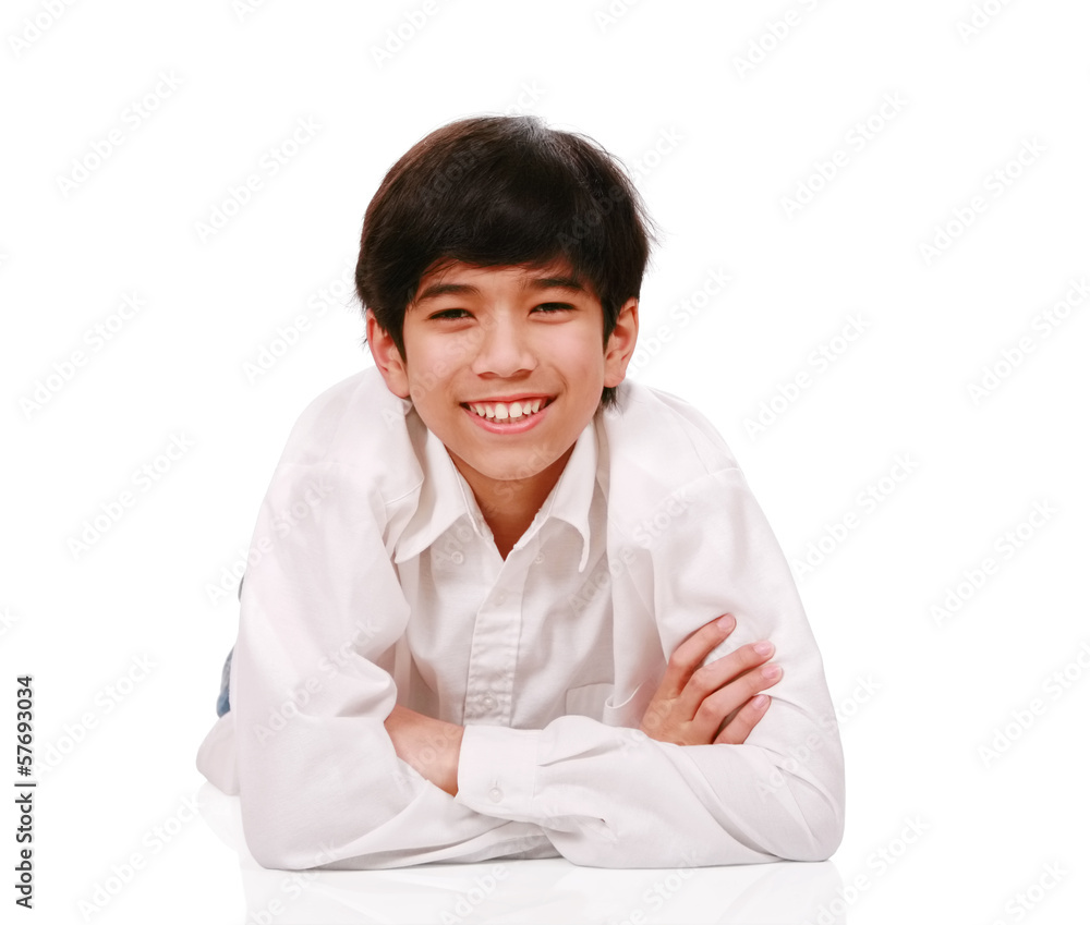 Handsome biracial teen boy smiling, lying down Handsome biracial teen boy smiling, lying down