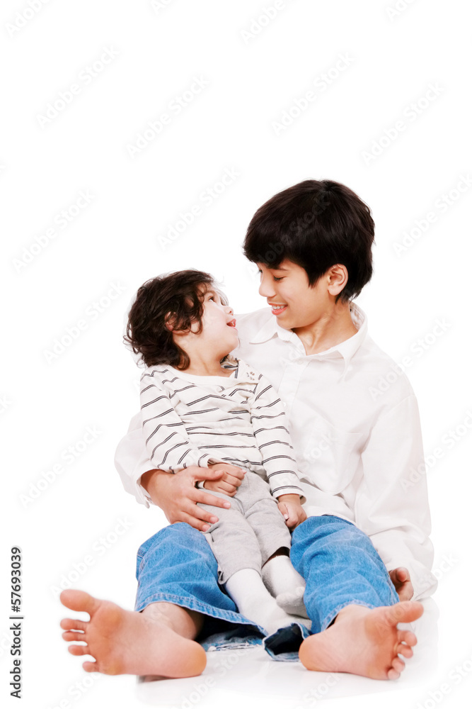 Big brother holding disabled two year old child. Child has cereb Big brother holding disabled two year old child. Child has cereb