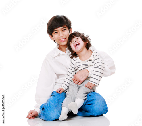 Konstfotografi Big brother holding disabled two year old child.