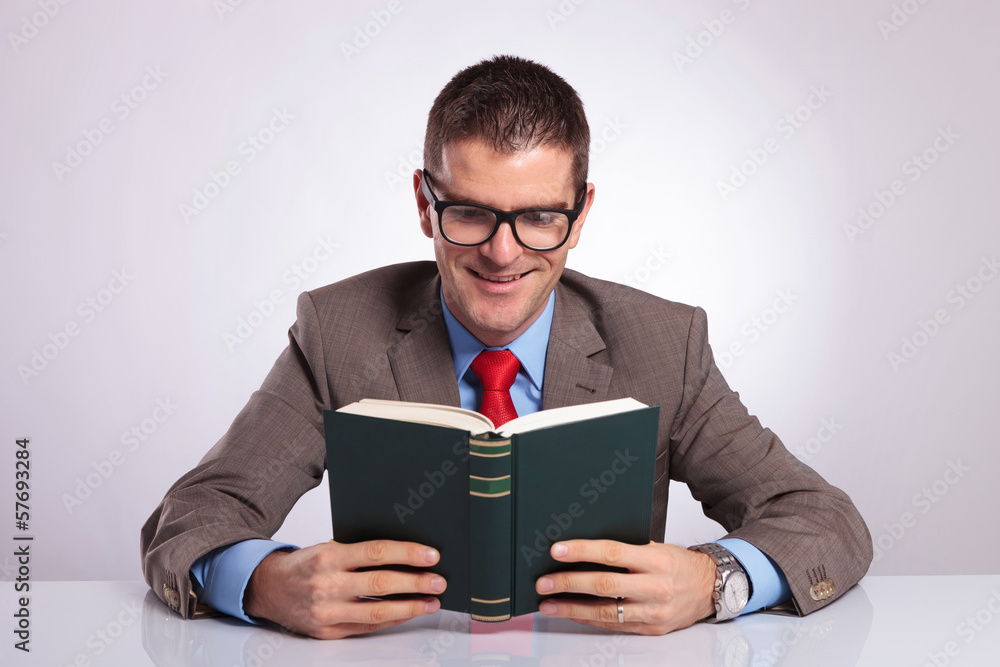 young business man holds book with both hands young business man holds book with both hands