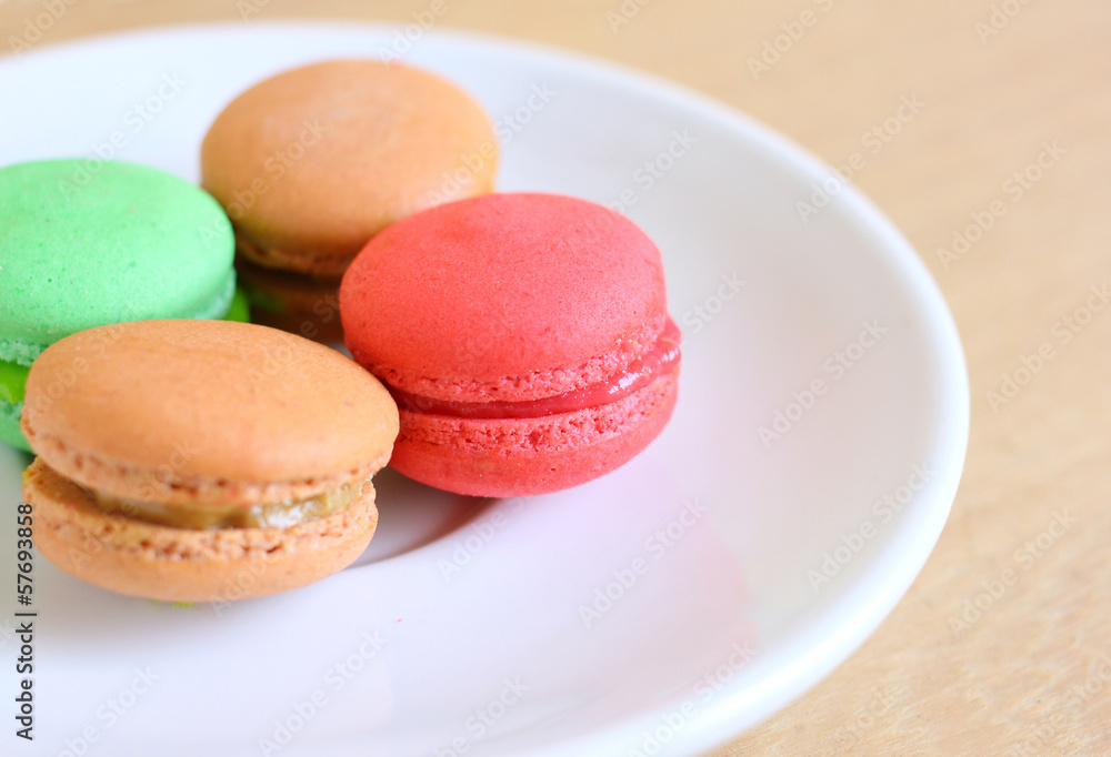 Tasty colorful macaroons on wooden background Tasty colorful macaroons on wooden background