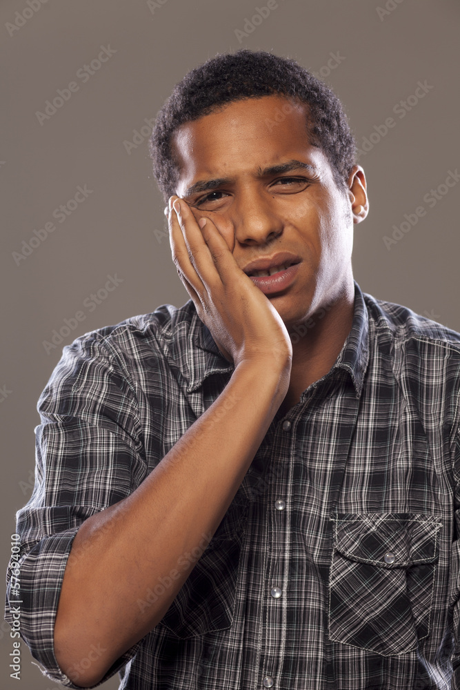 young African American young man with a strong toothache young African American young man with a strong toothache