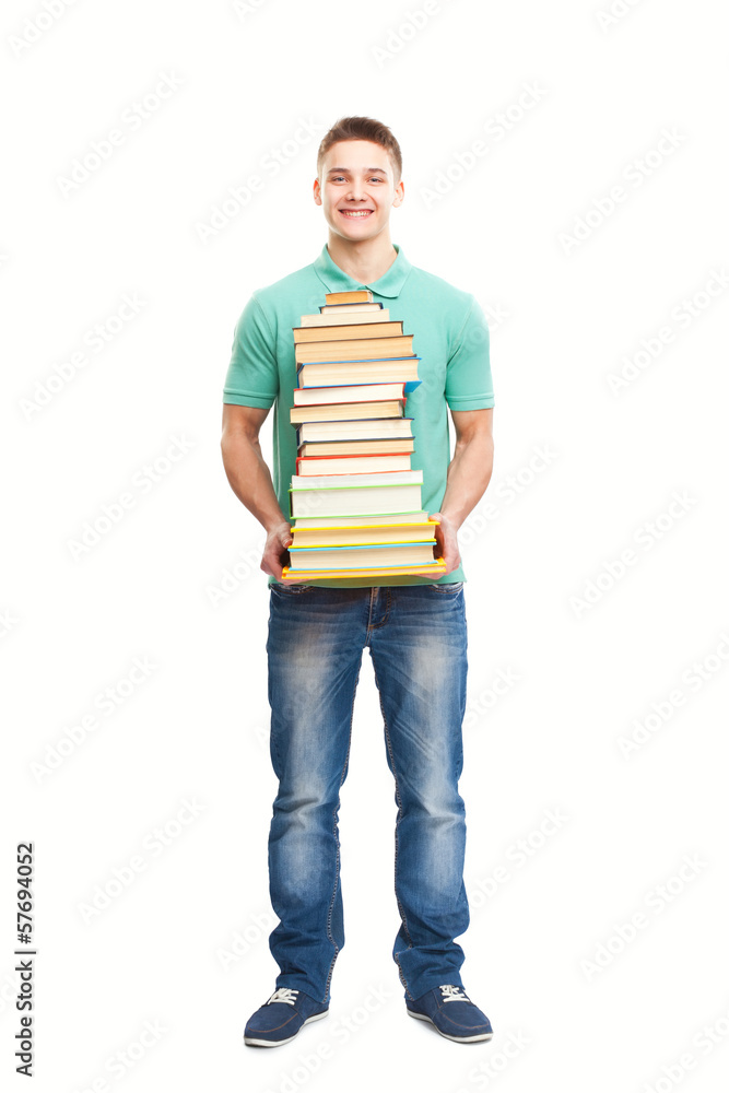 Smiling student holding big stack of books Smiling student holding big stack of books