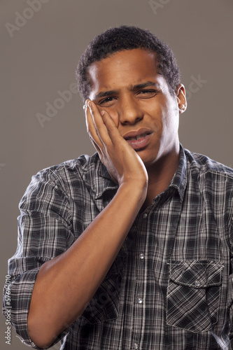 young African American young man with a strong toothache