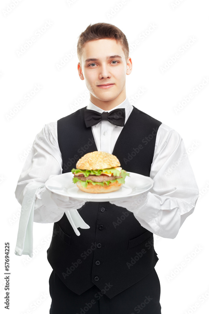 Young happy smiling waiter holding hamburger on plate Young happy smiling waiter holding hamburger on plate