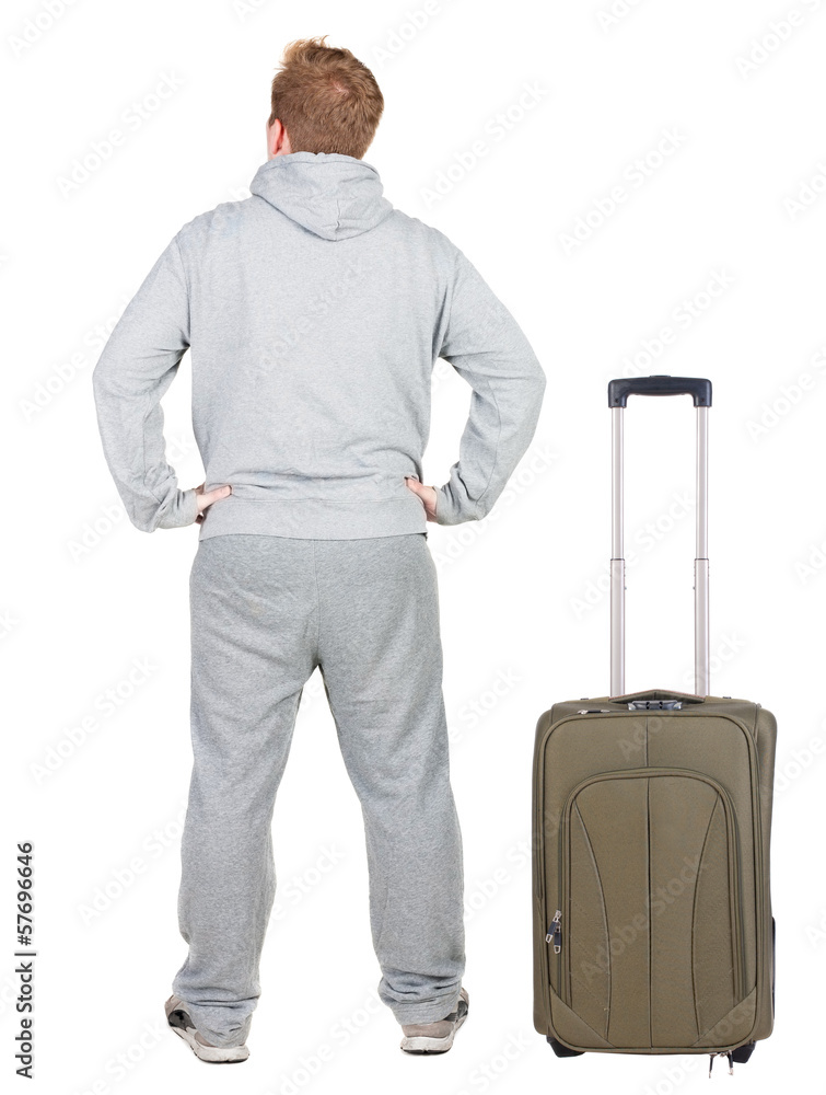 Back view of young man traveling with suitcas. Back view of young man traveling with suitcas.