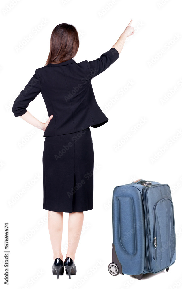 Back view of young brunette business woman traveling with suitca Back view of young brunette business woman traveling with suitca