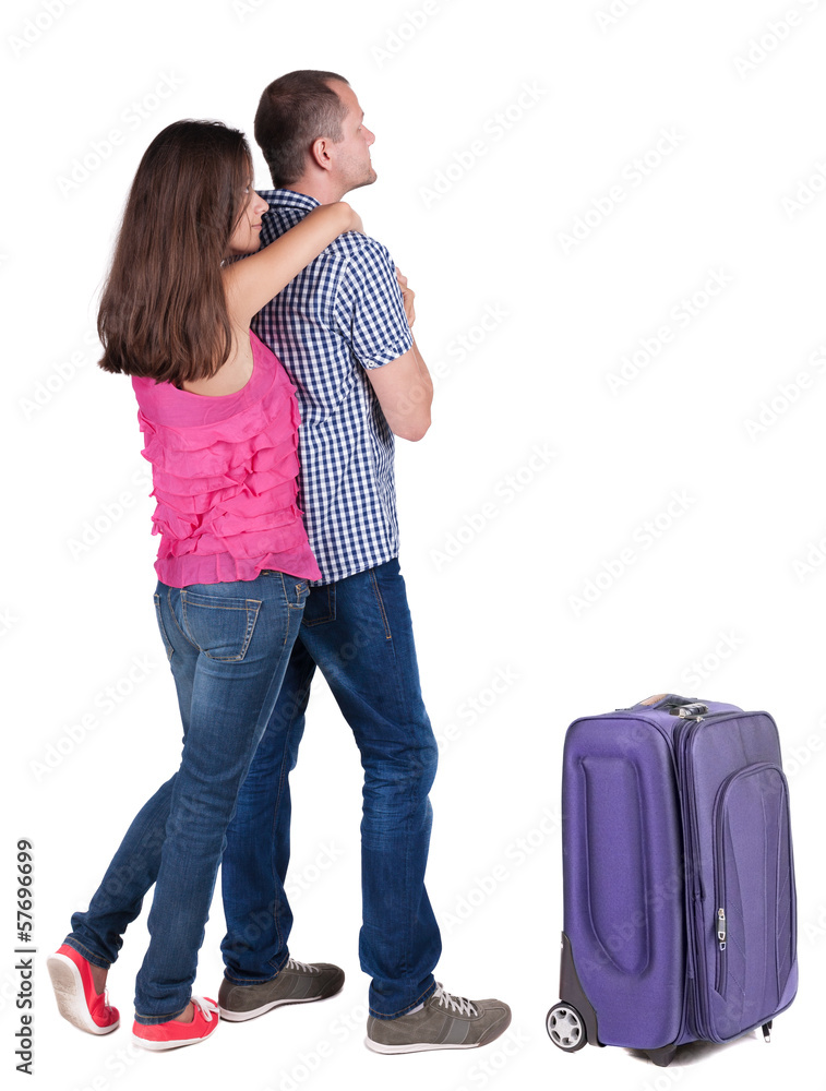 Back view of young couple traveling with suitcas . Back view of young couple traveling with suitcas .