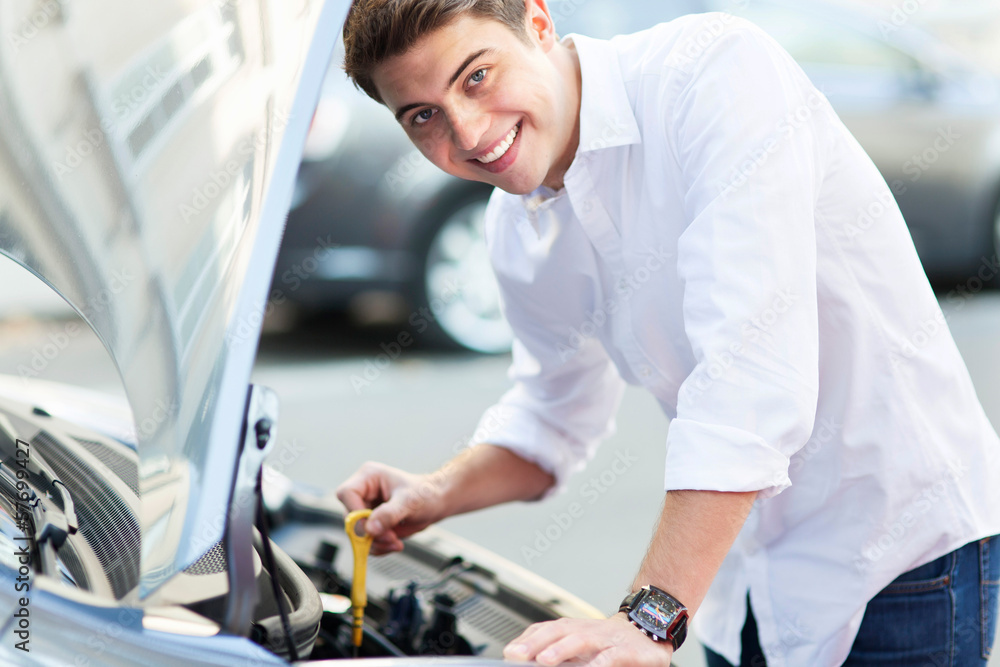 Man checking oil level in car Man checking oil level in car