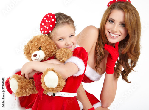 Woman and little girl wearing santa claus costume