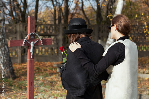 Two women at cemetery in fall
