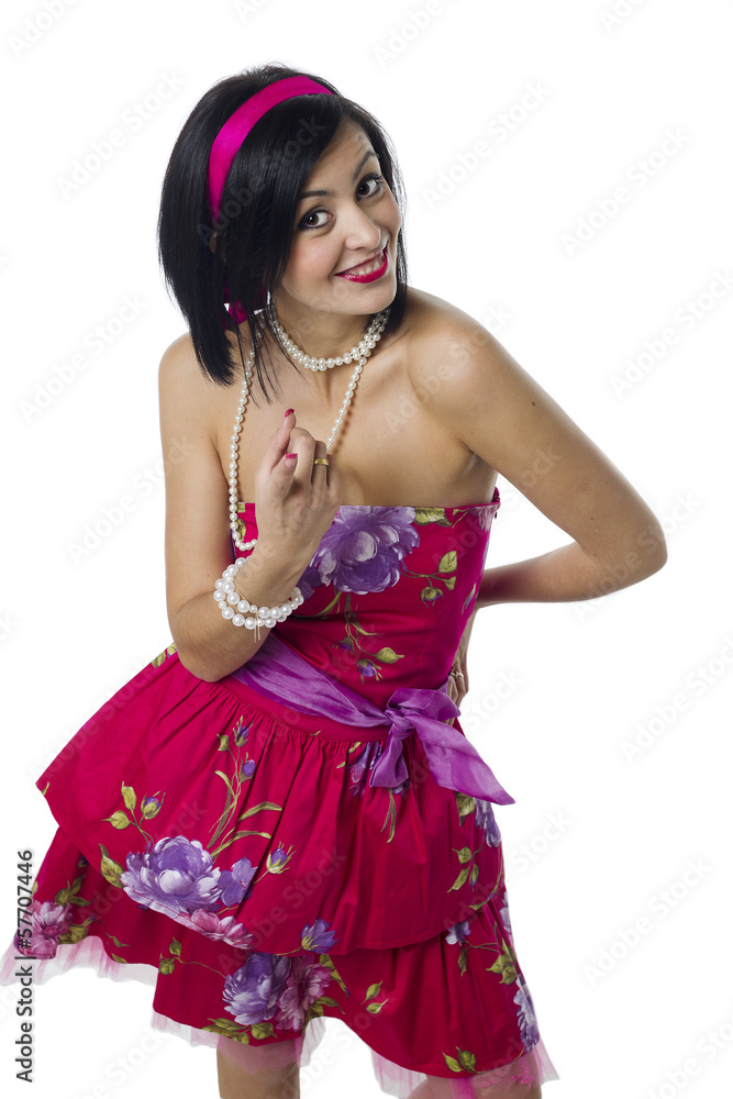 The dark-haired girl in a pink f dress on a white background