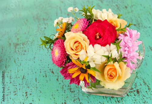 Beautiful bouquet of bright flowers in color vase,