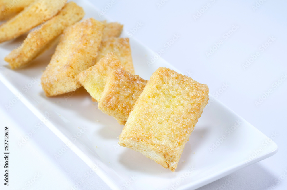 mini toasts with sugar close up on a white background mini toasts with sugar close up on a white background