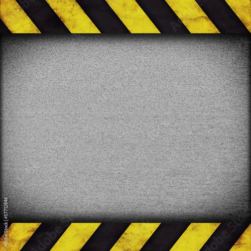 Warning stripes background with rusty plate