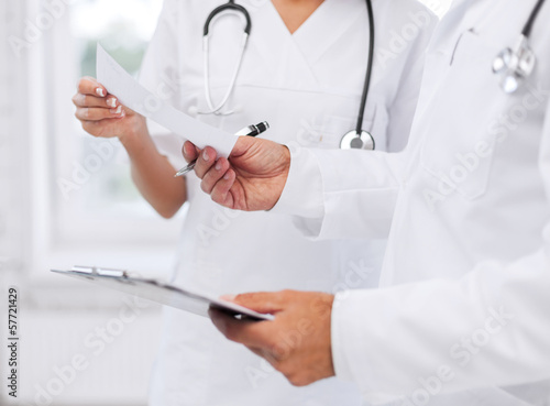 two doctors writing prescription