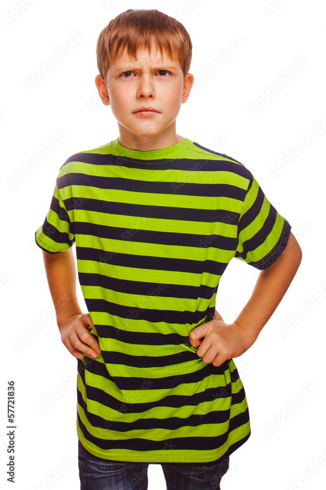 Blond gloomy serious boy in a green striped shirt thinking towar Blond gloomy serious boy in a green striped shirt thinking towar