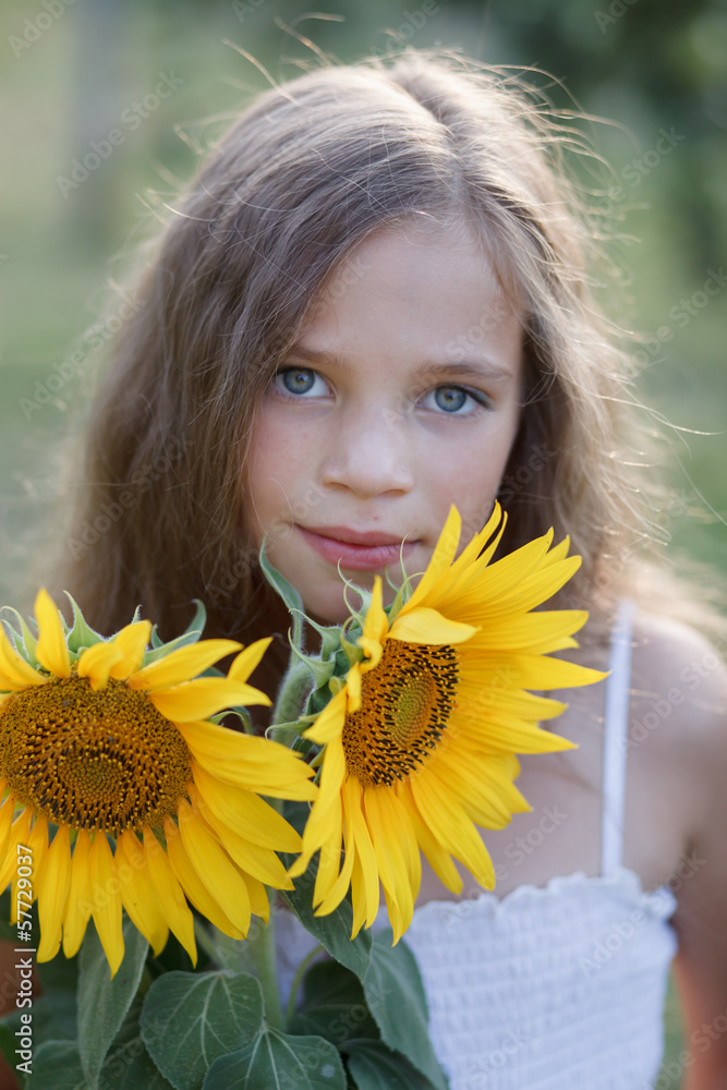 Young pretty woman on a sunflowers Young pretty woman on a sunflowers