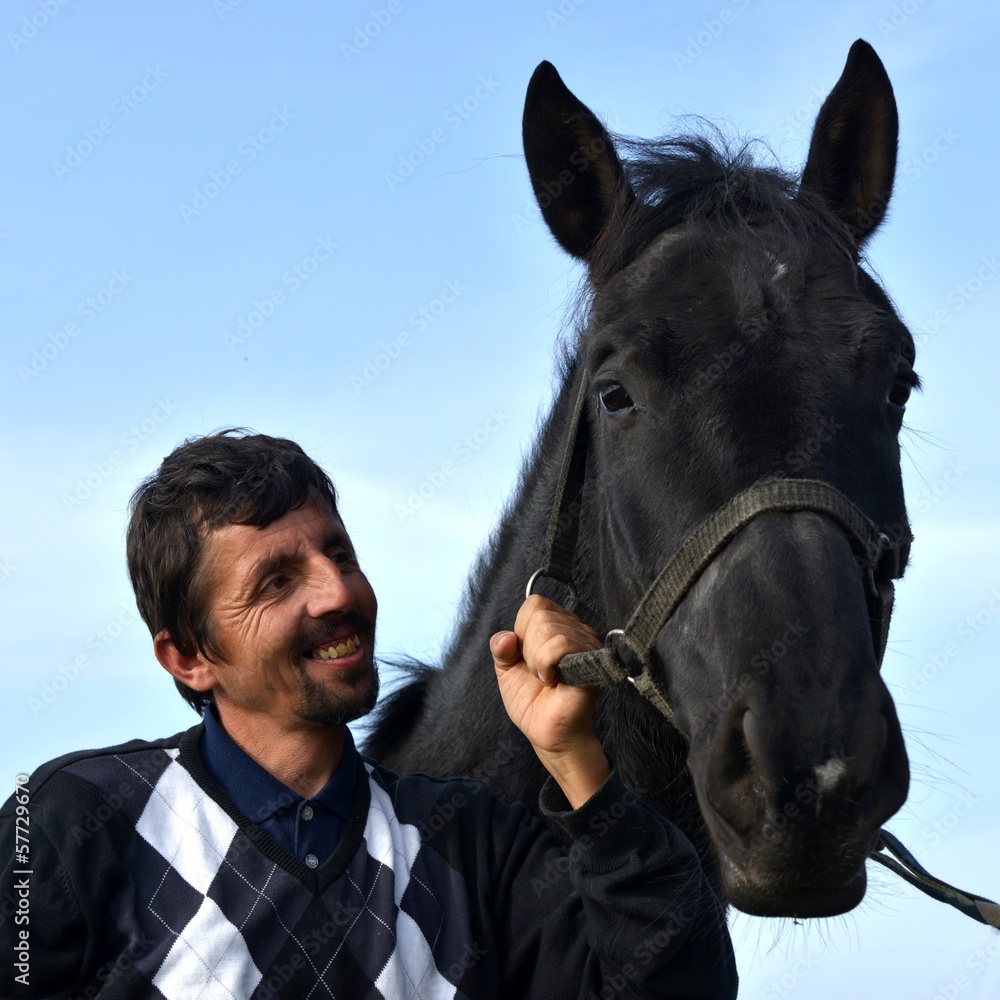 Fototapeta premium A young man with a horse.